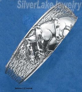 Sterling Silver Three Horseheads Cuff Bracelet On Textured Background